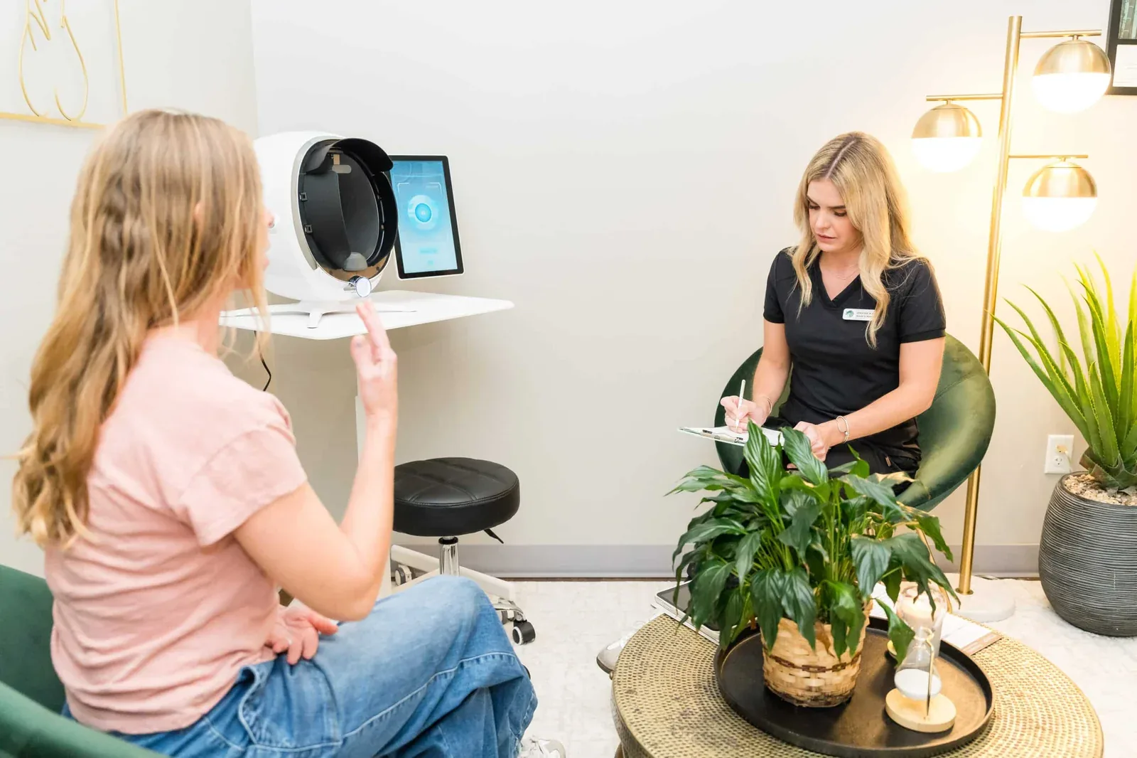 Esthetician performing a 3D AI skin analysis scan at Banyan & Bamboo in Austin
