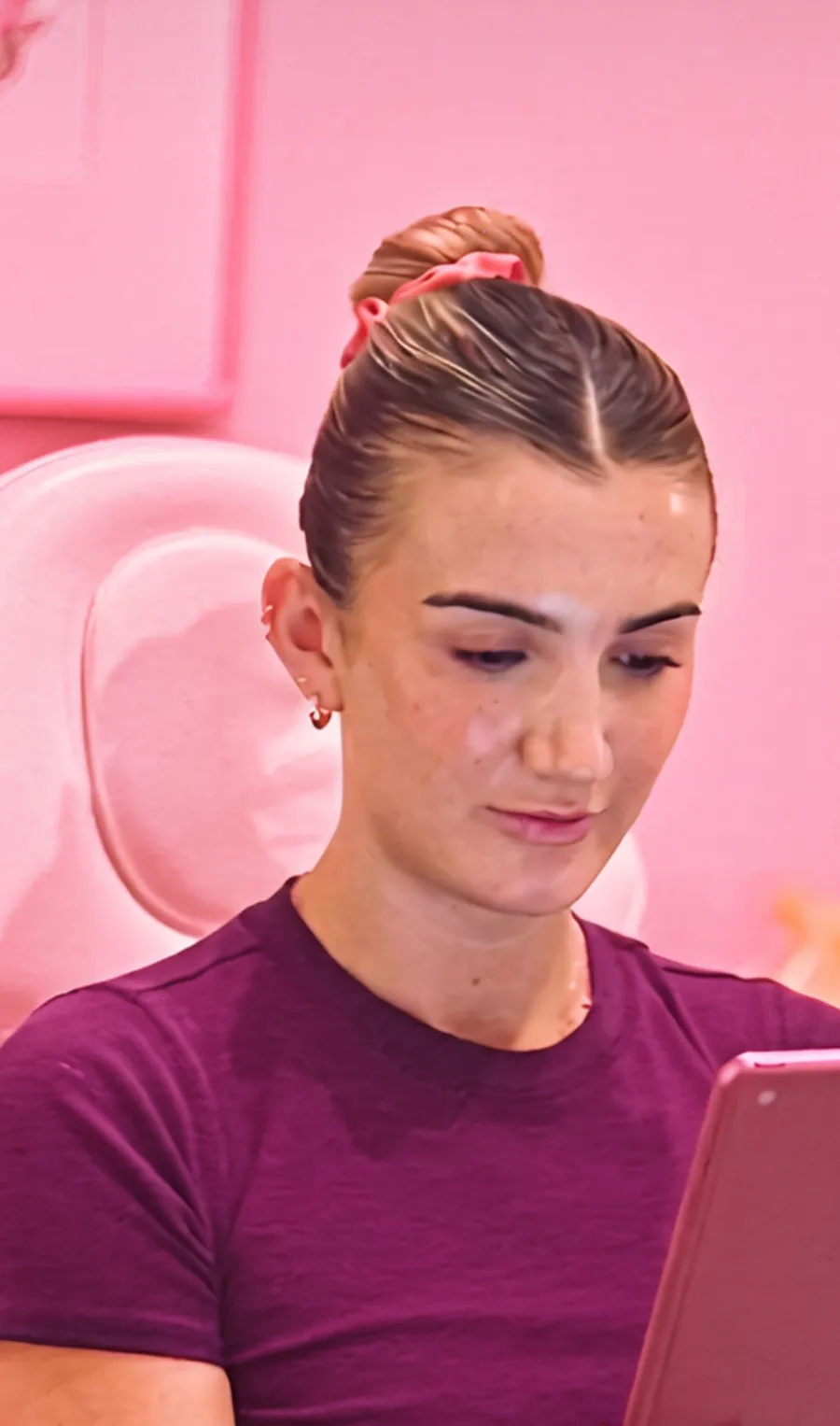 Patient reviewing her injectable treatment plan on a tablet before masseter Botox in Austin
