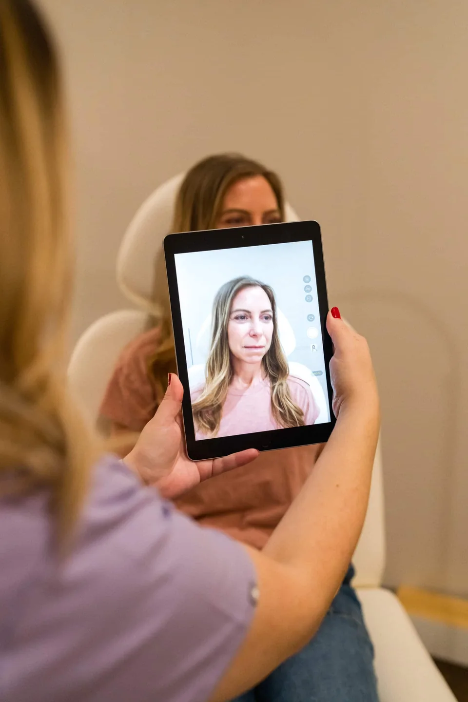 Brittany Cantu reviewing a 3D facial map with a patient at Banyan & Bamboo in Austin
